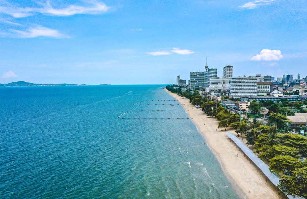 Aerial view of Jomtien Beach in Pattaya showing its long coastline, calm blue waters, and beachfront cityscape—ideal for families and peaceful getaways near Altera Hotel and Residence.