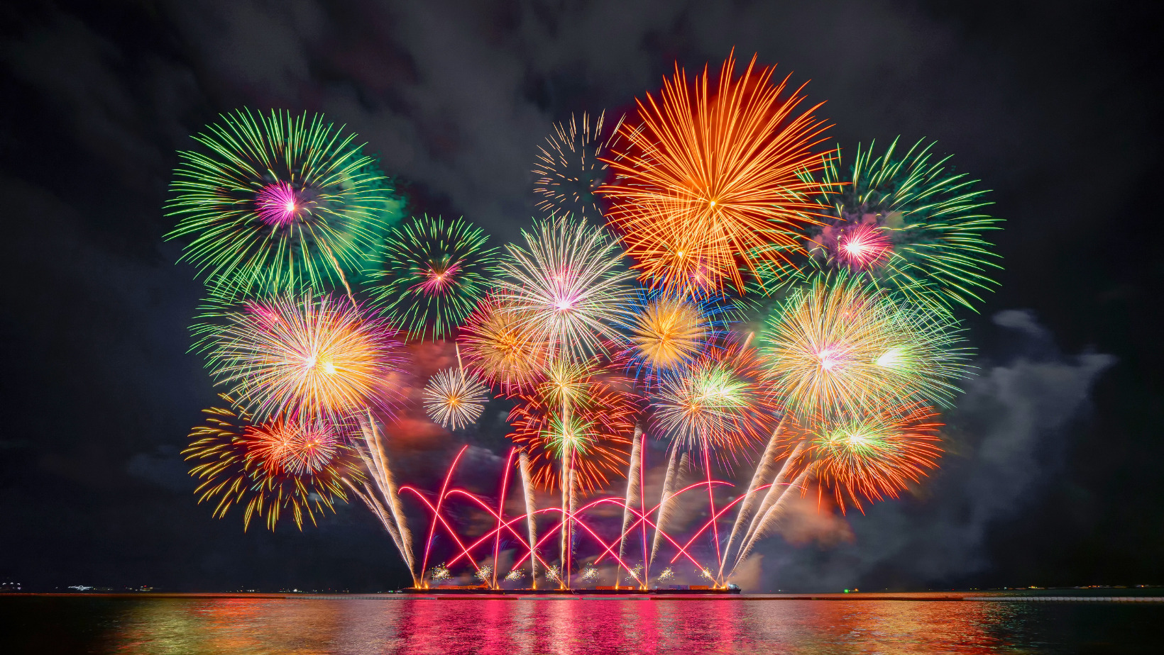Colorful fireworks lighting up the night sky over Pattaya Bay during the Pattaya Fireworks Festival 2025, reflecting on the water.