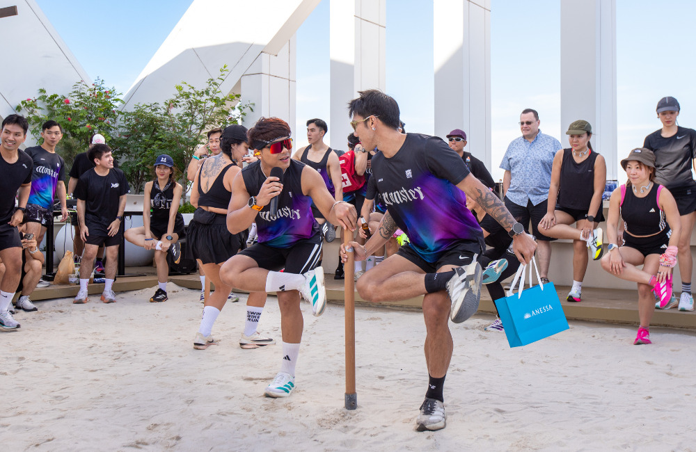 MONSTER.RUNBKK coaches leading a warm-up session with participants at the Pattaya Beach Run 2025 rooftop event, promoting active lifestyle and wellness community spirit in Pattaya.
