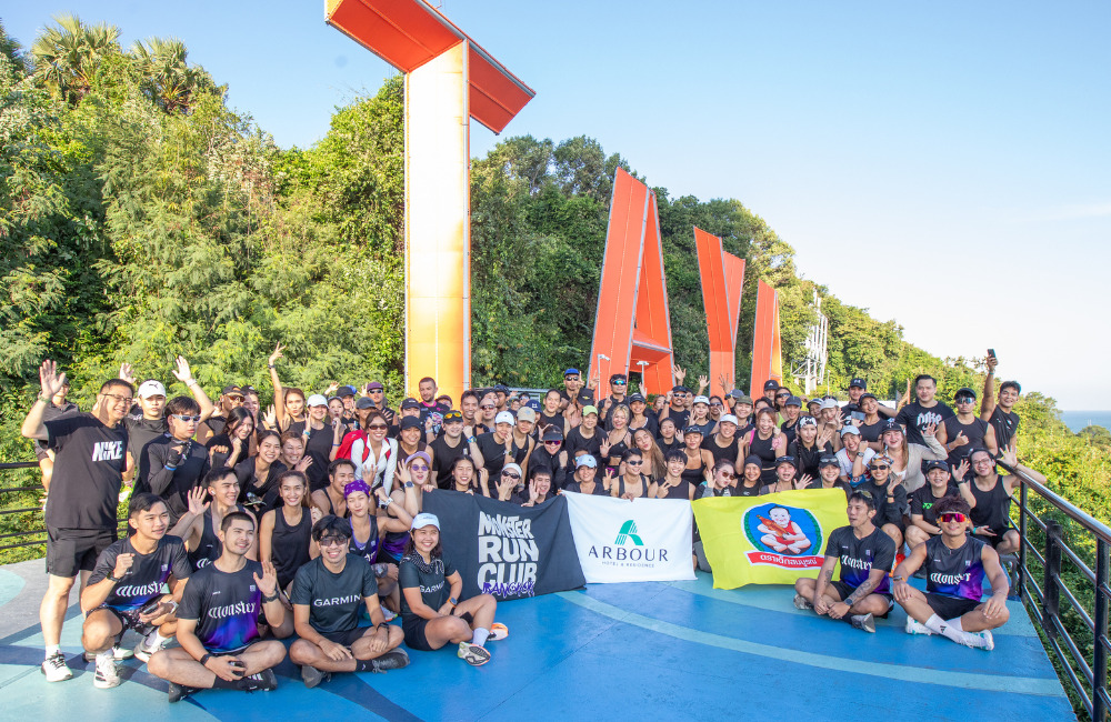 Group photo of Arbour Run Club, MONSTER.RUNBKK, and partners at the PATTAYA viewpoint, celebrating the success of Pattaya Beach Run 2025 and the growing wellness community in Pattaya.