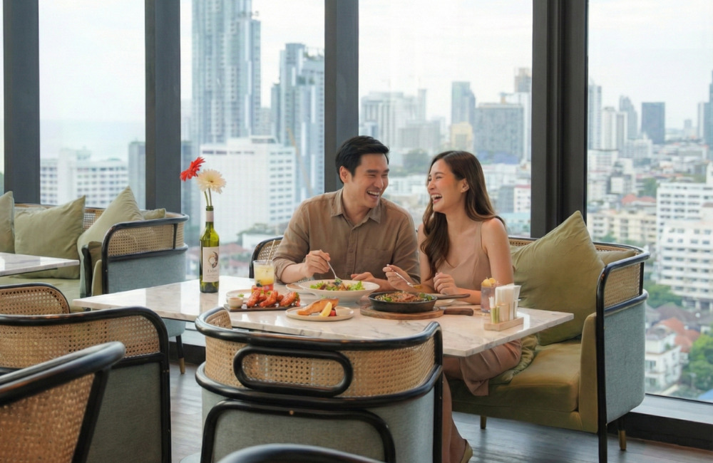 Couple sharing a romantic dinner at a rooftop restaurant in Pattaya, surrounded by city views and an intimate dining atmosphere