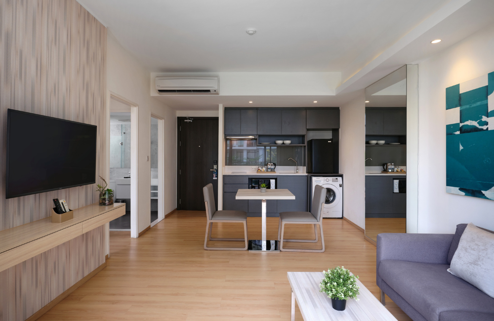 Spacious living and dining area with full kitchen and washing machine at Arden Hotel Pattaya—ideal for independent long-term stays.