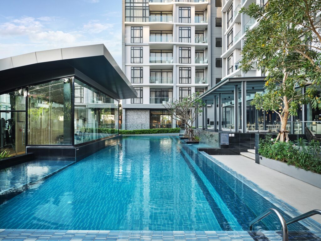 Modern outdoor swimming pool with children’s area and greenery at Arden Hotel Pattaya – perfect for family-friendly relaxation