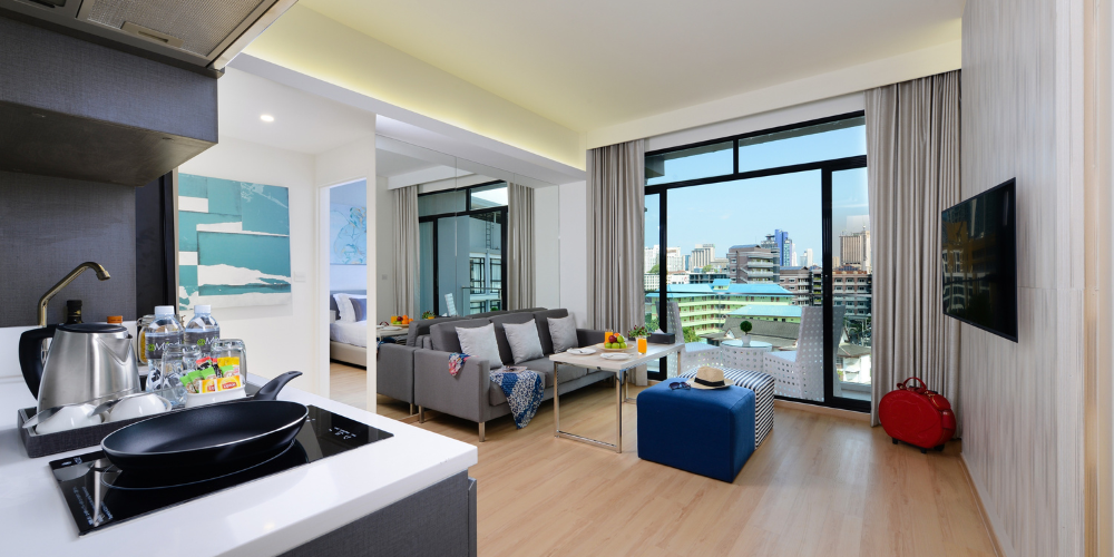 Modern family suite with kitchenette, separate living area, and city view balcony at Arden Hotel Pattaya