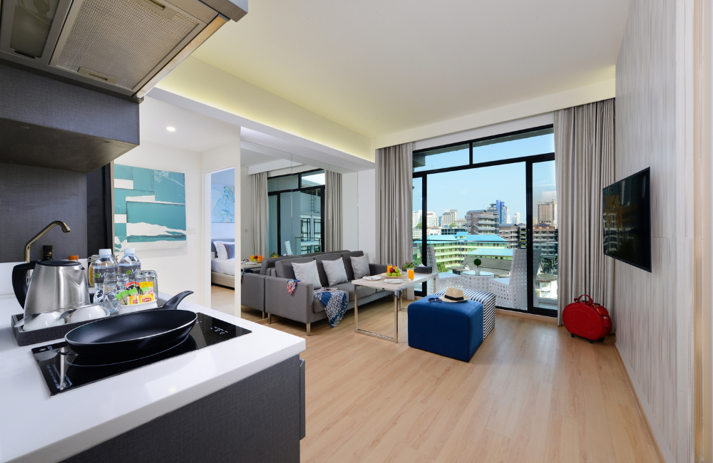 Modern family suite with kitchenette, separate living area, and city view balcony at Arden Hotel Pattaya