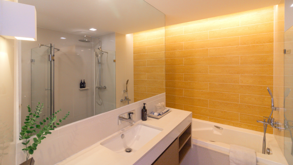 Modern bathroom at Aster Hotel and Residence Pattaya with bathtub, shower, and contemporary design