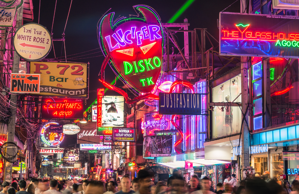 Colorful neon signs and bustling crowds along Walking Street Pattaya, a world-famous nightlife area near Hotel Amber Pattaya.