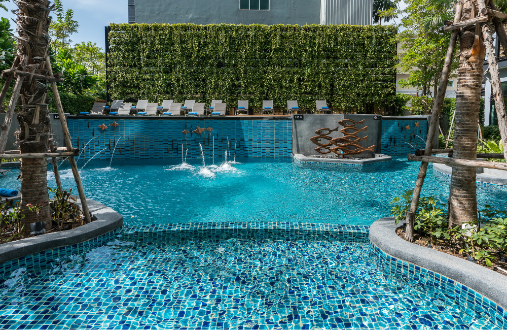 The refreshing outdoor swimming pool at Hotel Amber Pattaya, a perfect spot for guests who book our best available rate.