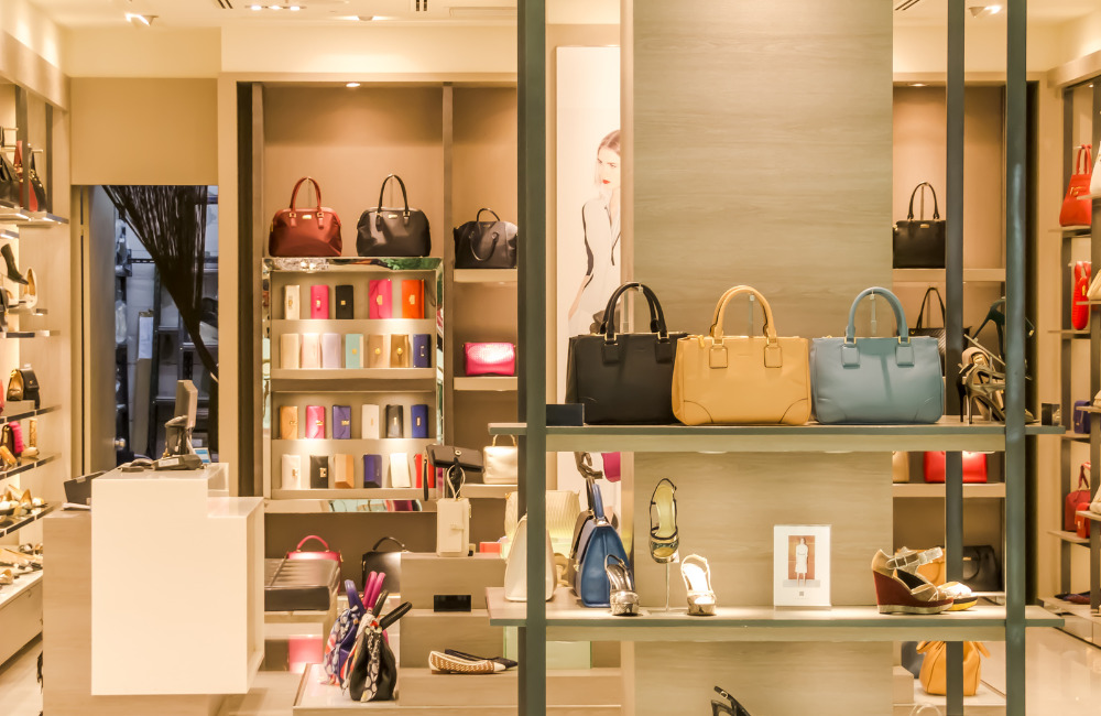 Displaying a variety of luxury handbags, wallets, and shoes, creating an inviting shopping environment for hotel guests.