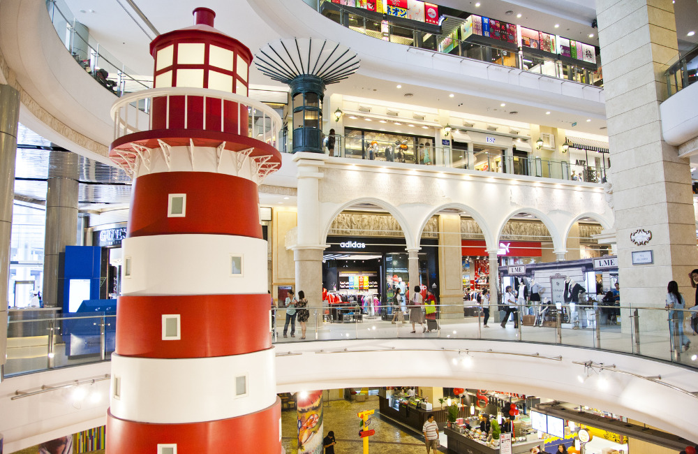 Interior of Terminal 21 Bangkok featuring a red lighthouse and international-themed shopping floors