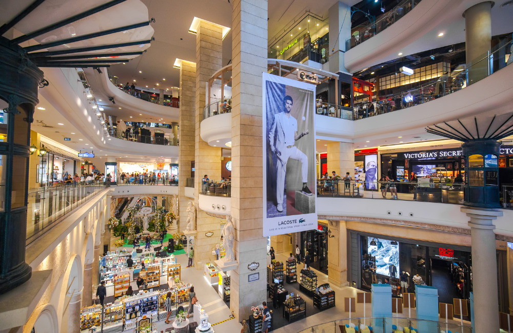 Multi-level view of Terminal 21 Bangkok with fashion stores and Lacoste advertisement