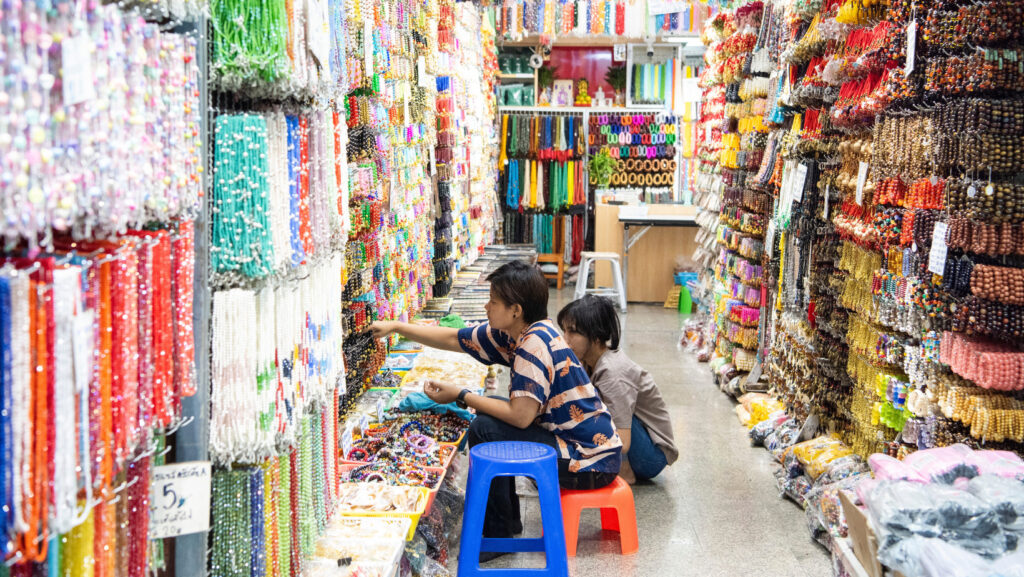 Shoppers buying colorful beads at Sampeng Market Bangkok location in Chinatown