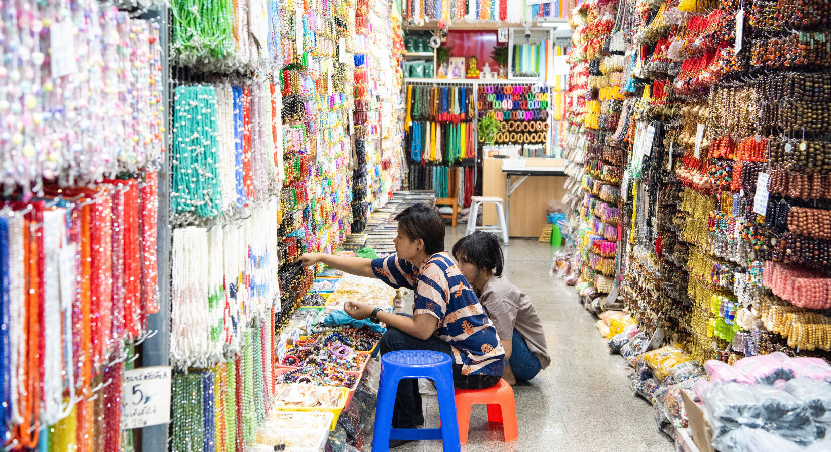Shoppers buying colorful beads at Sampeng Market Bangkok location in Chinatown