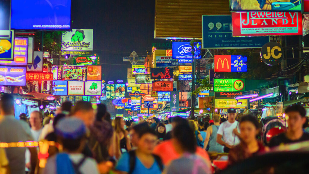 Vibrant Khaosan Road nightlife with neon lights and crowded bars