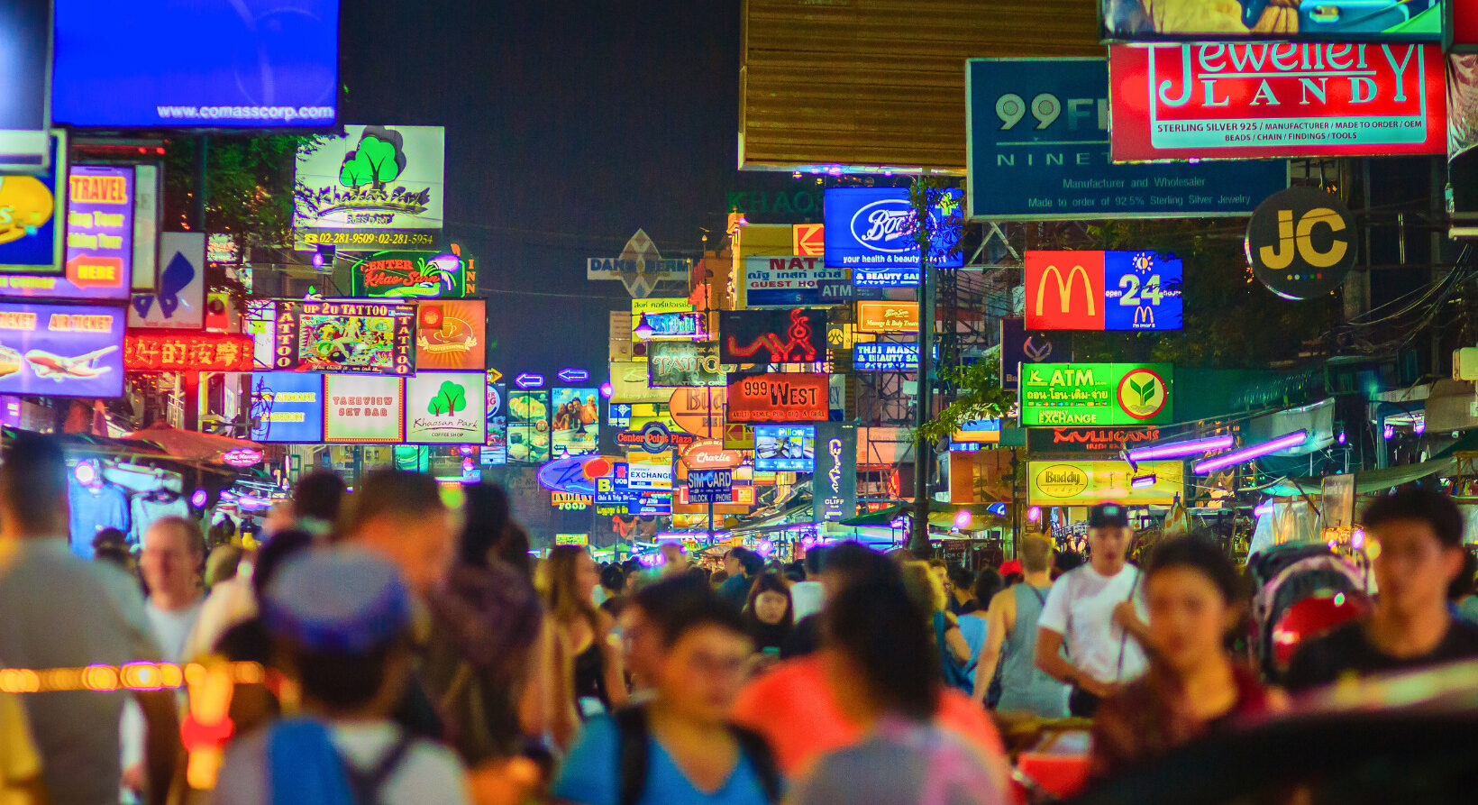 Vibrant Khaosan Road nightlife with neon lights and crowded bars