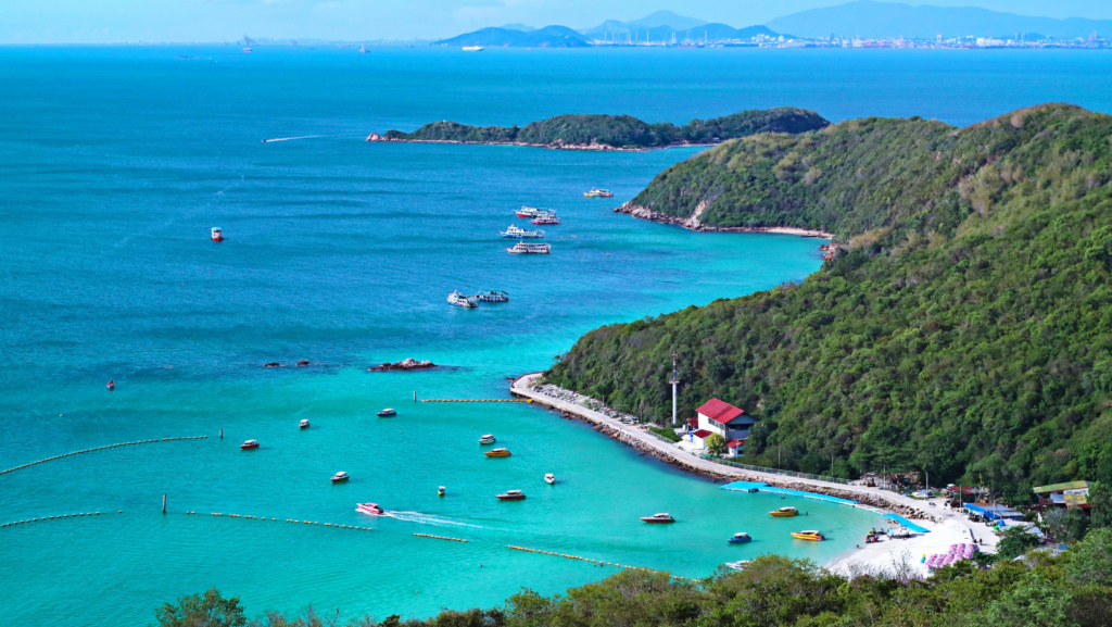 Panoramic sea view of Koh Larn Island with turquoise water, green hills and boats near Pattaya